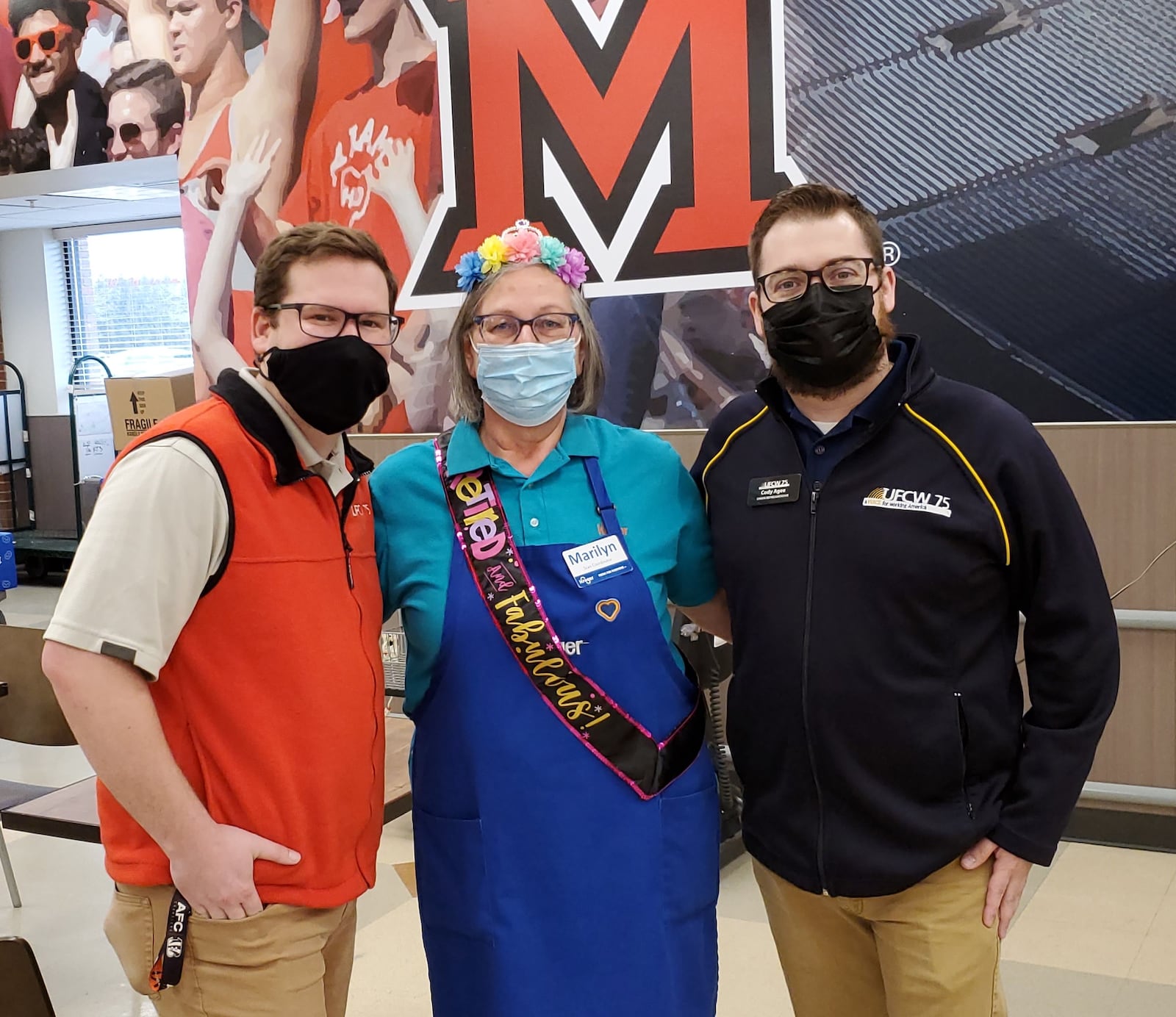 Among the many people stopping by the congratulate Marilyn Wuestefeld on her retirement were Steven Nichols, left, and Cody Agee, union representatives from United Food and Commercial Workers Union Local 75, who presented her with a gift of a union jacket. CONTRIBUTED/BOB RATTERMAN