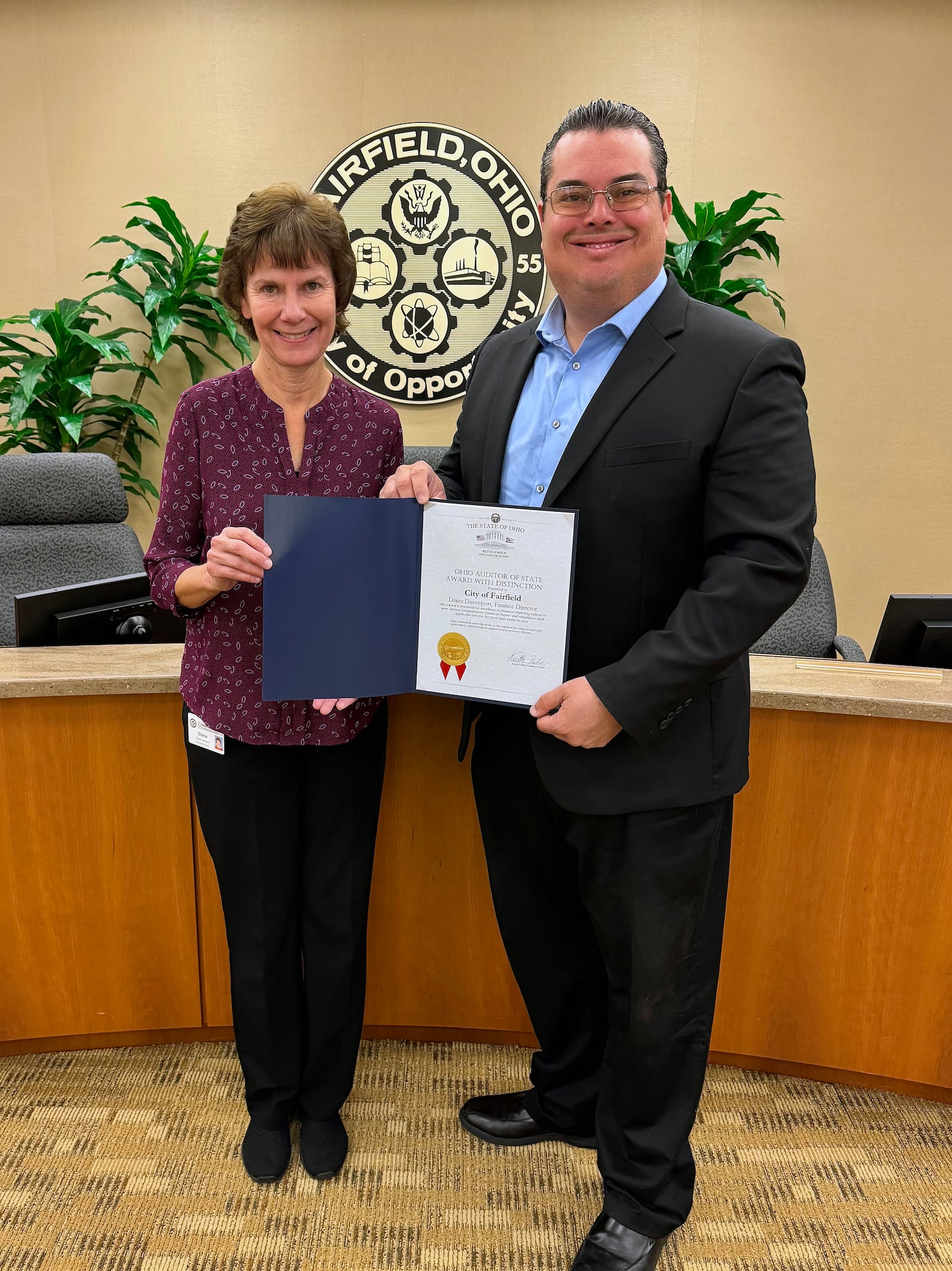 Fiscal officer Diana Davenport (left) accepts the Ohio Auditor of State Award with Distinction for its 2024 audit from Ryan Holiday, Southwest Regional liaison with the Ohio Auditor of State. CITY OF FAIRFIELD / CONTRIBUTED
