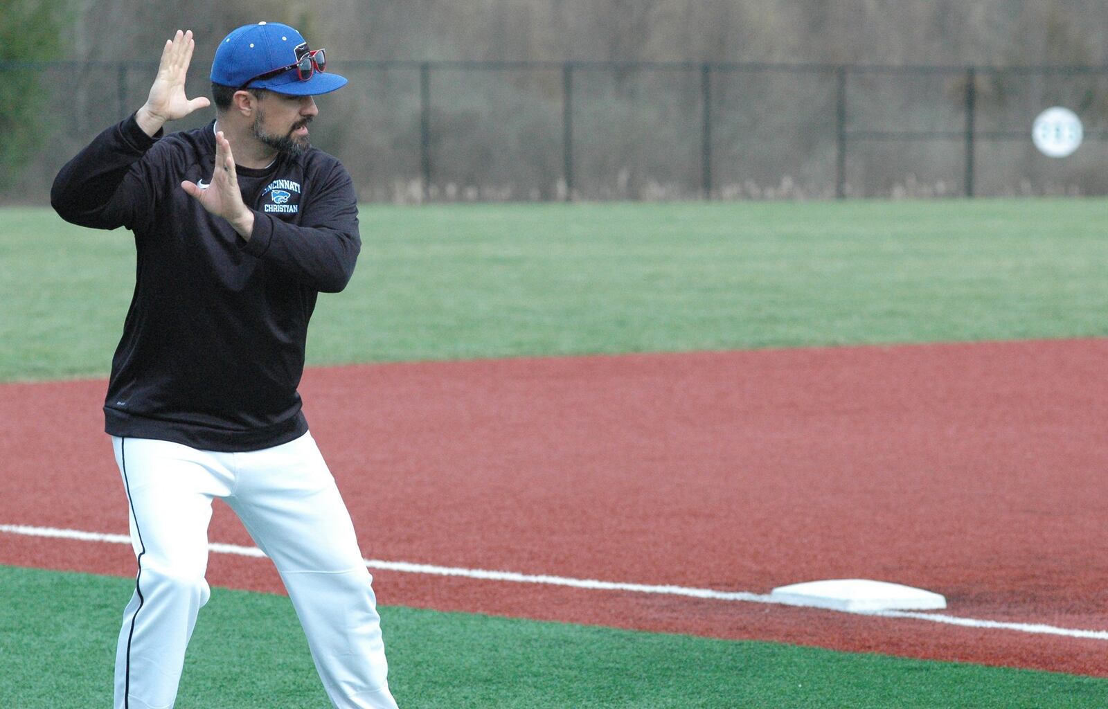 Cincinnati Christian coach Curtus Moak makes a point in the third-base coaching box during Thursday’s baseball game against Clark Montessori at the West Chester Baseball Complex. CCS won 12-0 in five innings. RICK CASSANO/STAFF