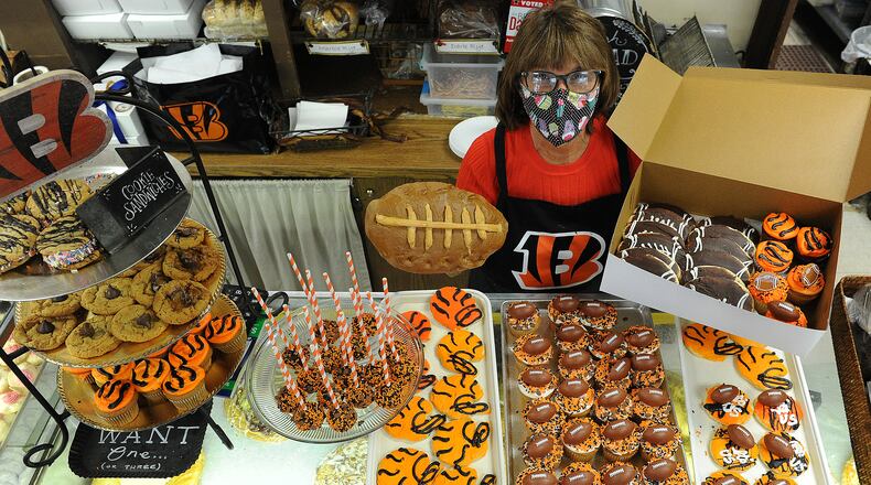 Theresa Hammons the owner of Ashley's Pastry Shop located at 21 Park Ave. displays all the Bengal treats they have for sale. Football bread, cupcakes, cookies and cake pops. MARSHALL GORBY\STAFF