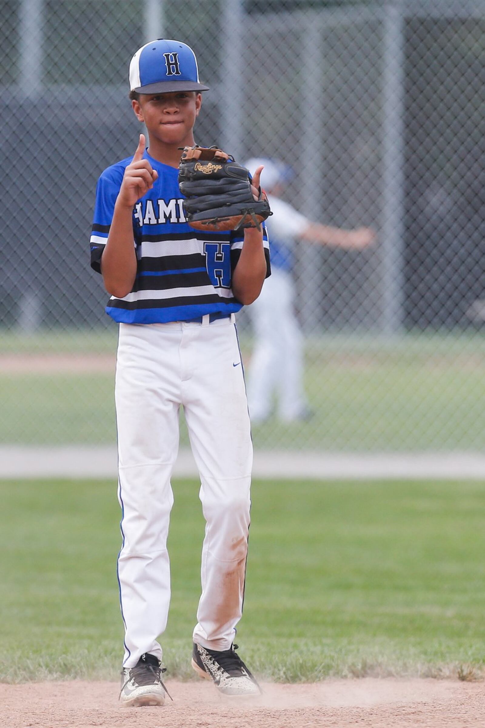 Hamilton West Side’s Braedyn Moore finishes some warmup throws during Thursday’s winners’ bracket final against Canfield in the Ohio Little League 12-year-old baseball tournament at Ford Park in Maumee. CONTRIBUTED PHOTO BY SCOTT GRAU