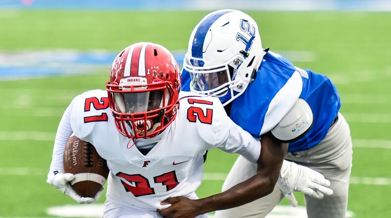 Fairfield’s Dashaun Simpkins carries the ball as Hamilton’s James Turner comes in for a tackle during a Sept. 7 game at Virgil Schwarm Stadium in Hamilton. The visiting Indians won 40-6. NICK GRAHAM/STAFF