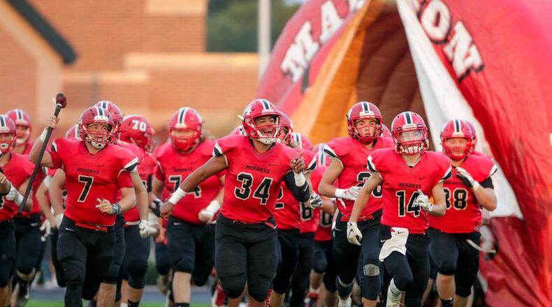 The Madison Mohawks take the field before their 54-0 victory over visiting Carlisle on Oct. 5 at Brandenburg Field in Madison Township. NICK GRAHAM/STAFF