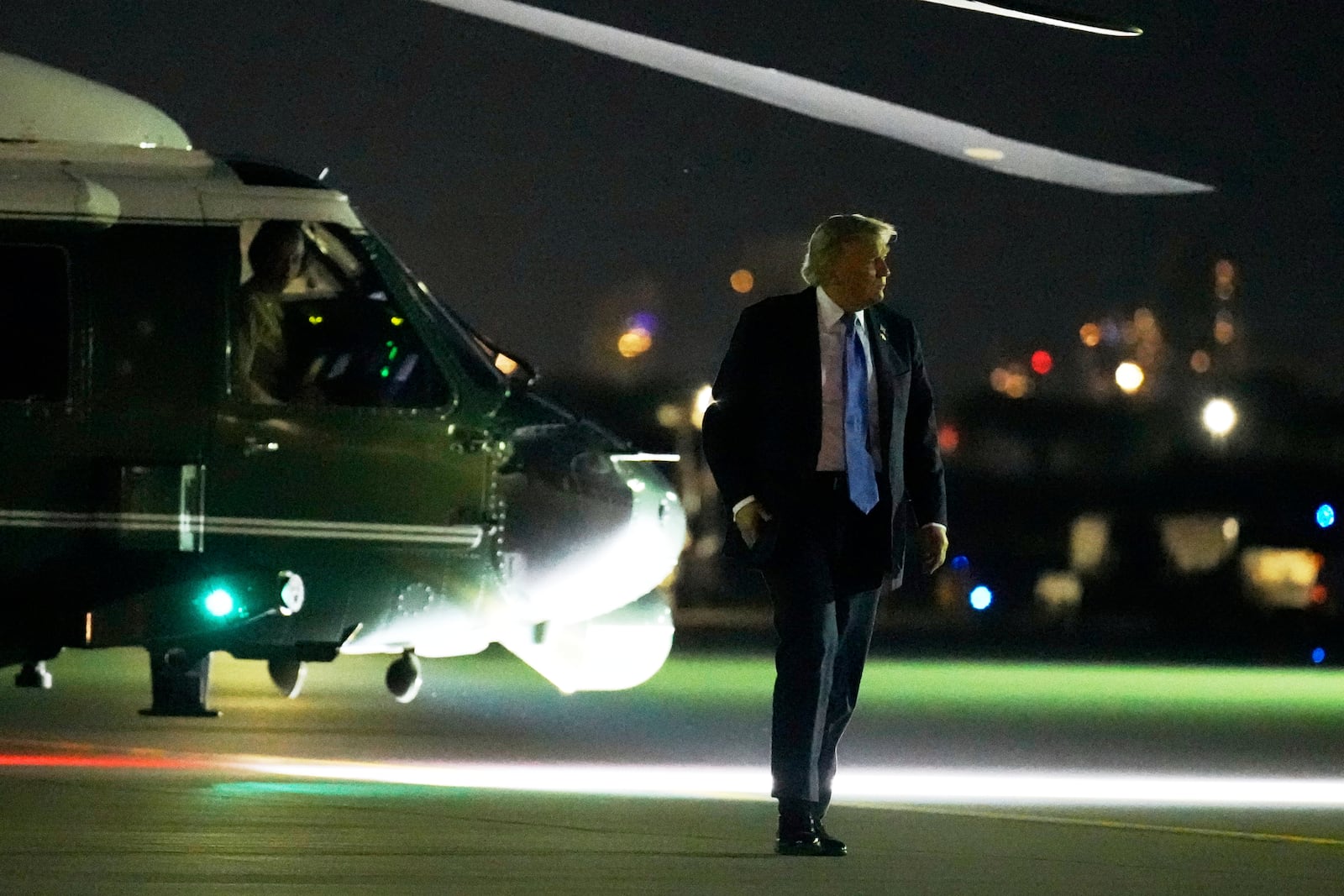 President Donald Trump walks from Marine One to board Air Force One at Calgary International Airport, Monday, June 16, 2025, in Calgary, Canada, on his way back to Washington. (AP Photo/Mark Schiefelbein)