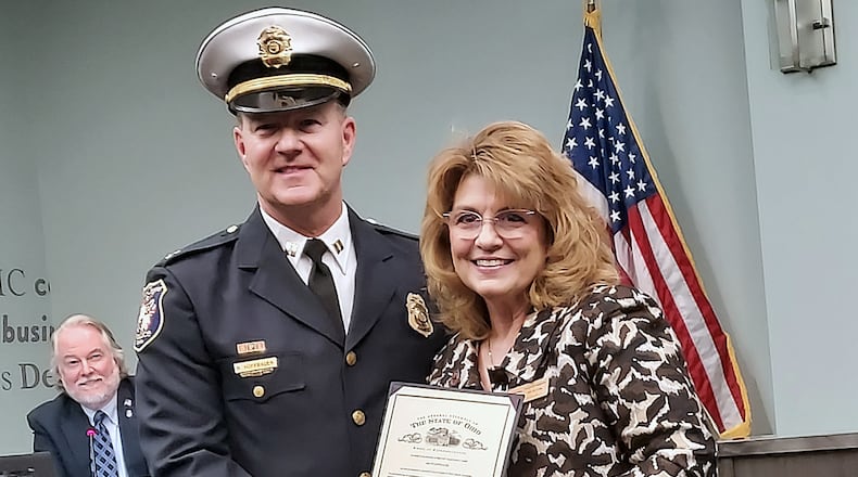Ohio Rep. Jennifer Gross presented Bruce Hoffbauer a commendation from legislators after he was sworn in as West Chester Twp.’s assistant police chief. Photo: Sue Kiesewetter/for the Journal-News