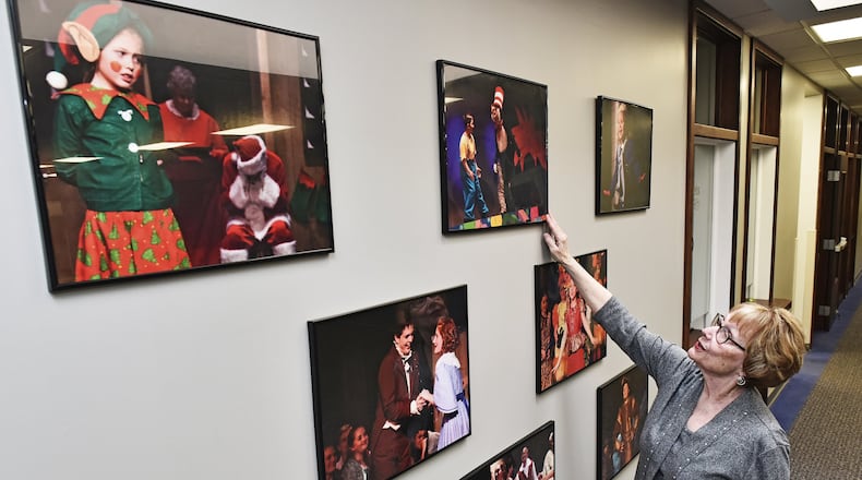 Nina Markle, executive director of the Performing Arts Academy, points to photographs of children performing in some of their plays inside the facility on Lewis Street in Middletown. The Performing Arts Academy offers individual lessons in Voice, piano, guitar, drums and other instruments and performs up to ten plays a year serving several hundred students. NICK GRAHAM/STAFF