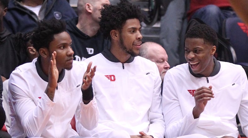 Dayton’s John Crosby, Xeyrius Williams and Kostas Antetokounmpo watch a game against Fordham from the bench on Saturday, Feb. 17, 2018, at UD Arena. David Jablonski/Staff