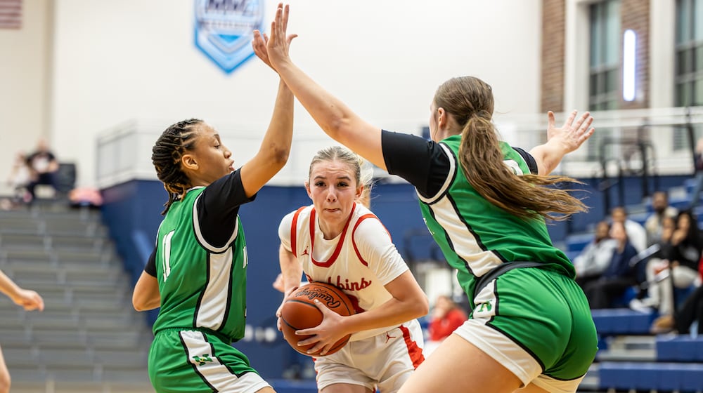 Stebbins High School senior Aubrey Fritz drives past Northmont sophomore Sophie Secor (right) and freshman Ashlen Simpson during their Division II district semifinal game on Wednesday, Feb. 25, 2026 at Fairborn's Skyhawk Arena. The Indians won 52-42. MICHAEL COOPER / STAFF