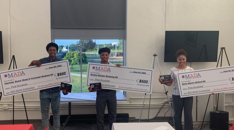 Three of the four winners of the Minority Athletic Directors Association scholarships pose for a photo Wednesday: Courtney “Duece” Blake (Trotwood-Madison High School); Nathan Glisson (Wyoming High School); and Devin Morris (Milford High School).