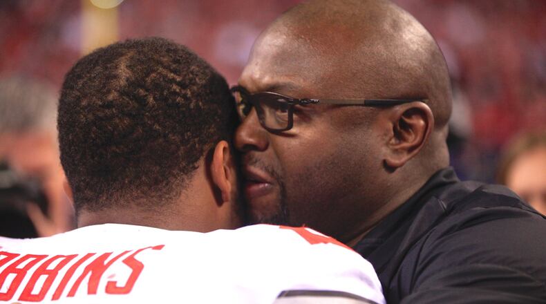 Ohio State running backs coach Tony Alford, right, hugs J.K. Dobbins after a victory against Wisconsin in the Big Ten Championship on Dec. 2, 2017, at Lucas Oil Stadium in Indianapolis. David Jablonski/Staff