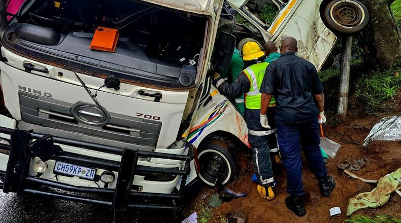 In this photo provided by ALS Paramedics on Thursday, Jan. 29, 2026, rescue personnel inspect the site of a collision involving a minibus taxi and a truck, near Durban, South Africa. (ALS Paramedics via AP Photo)