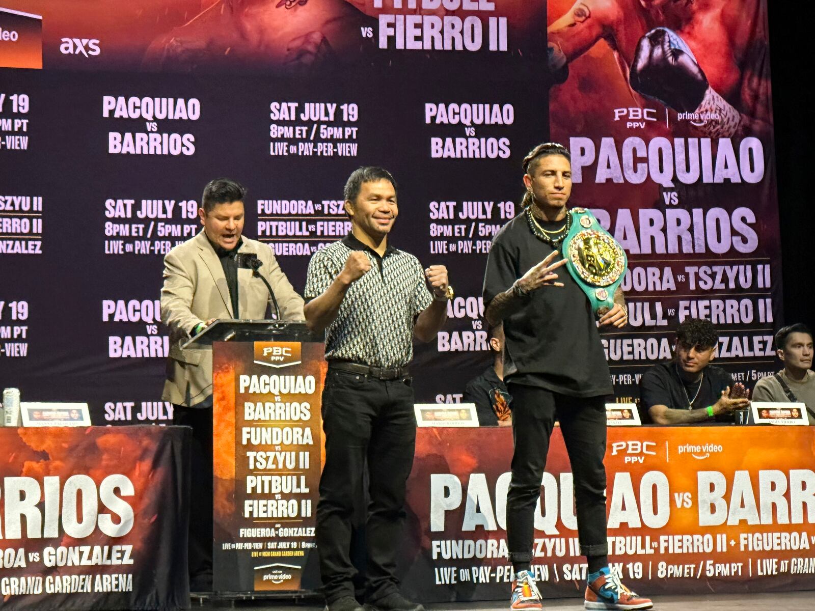 Manny Pacquiao, center, and WBC welterweight champion Mario Barrios pose at a news conference in Los Angeles on Tuesday, June 3, 2025. (AP Photo/Greg Beacham)