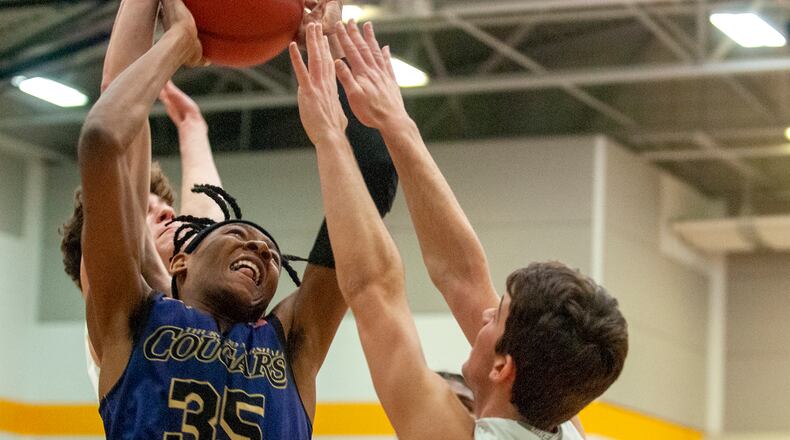 Thurgood Marshall’s Prophet Johnson tries to score against Chaminade Julienne during Saturday night’s sectional final at Springfield High School. Johnson scored 12 points and the Cougars advanced to a district final with a 57-35 victory. Jeff Gilbert/CONTRIBUTED