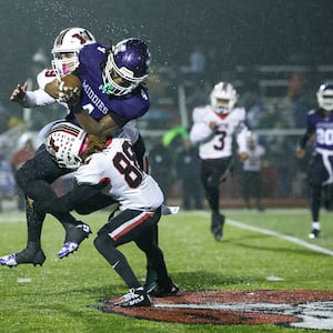 Middletown's Jordan Vann get hit by Wayne's James Dyer IV during their Division I Regional football final Friday, Nov. 21, 2025 at Trotwood Madison High School. Middletown won 21-14 to advance. NICK GRAHAM/STAFF