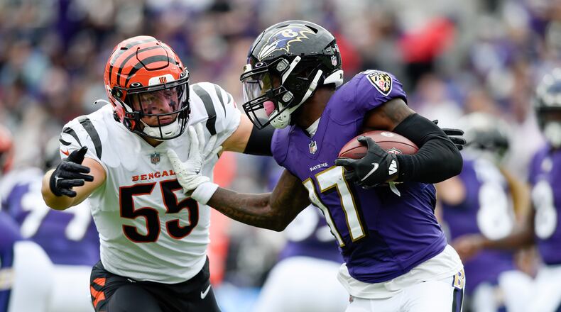 Baltimore Ravens running back Le'Veon Bell (17) applies a stiff arm on Cincinnati Bengals linebacker Logan Wilson (55) during the first half of an NFL football game, Sunday, Oct. 24, 2021, in Baltimore. (AP Photo/Gail Burton)