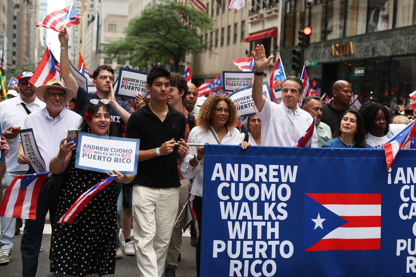 New York City mayoral candidate Andrew Cuomo, center, waves as he walks in the Puerto Rican Day Parade, Sunday, June 8, 2025, in New York. (AP Photo/Heather Khalifa)
