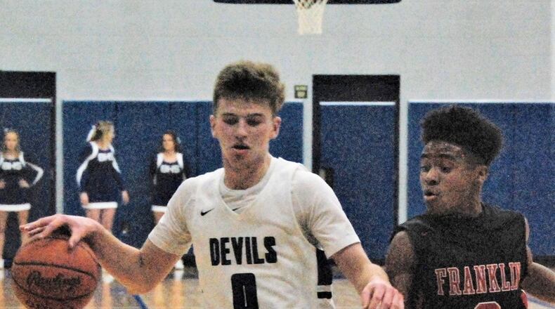 Brookville’s Jacob Gudorf (left) pushes the ball up the court against Franklin’s Kamry Fuller on Friday night at Brookville. The host Blue Devils won 75-60. CONTRIBUTED PHOTO BY OLIVER SANDERS
