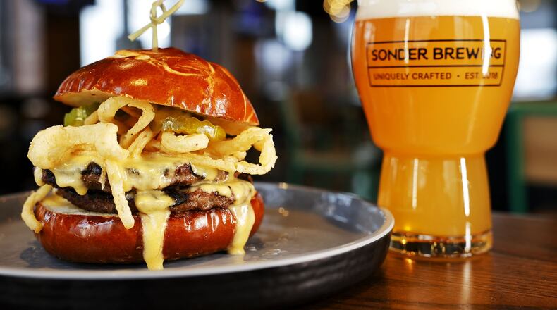 Sonder Brewing Taphaus & Kitchen is now open at 9558 Civic Centre Blvd. in West Chester Township featuring a large selection of Sonder beers and a food choices including burgers, salads, shareables and more. This is their Voss Boss Burger paired with a You Betcha! New England IPA. NICK GRAHAM/STAFF