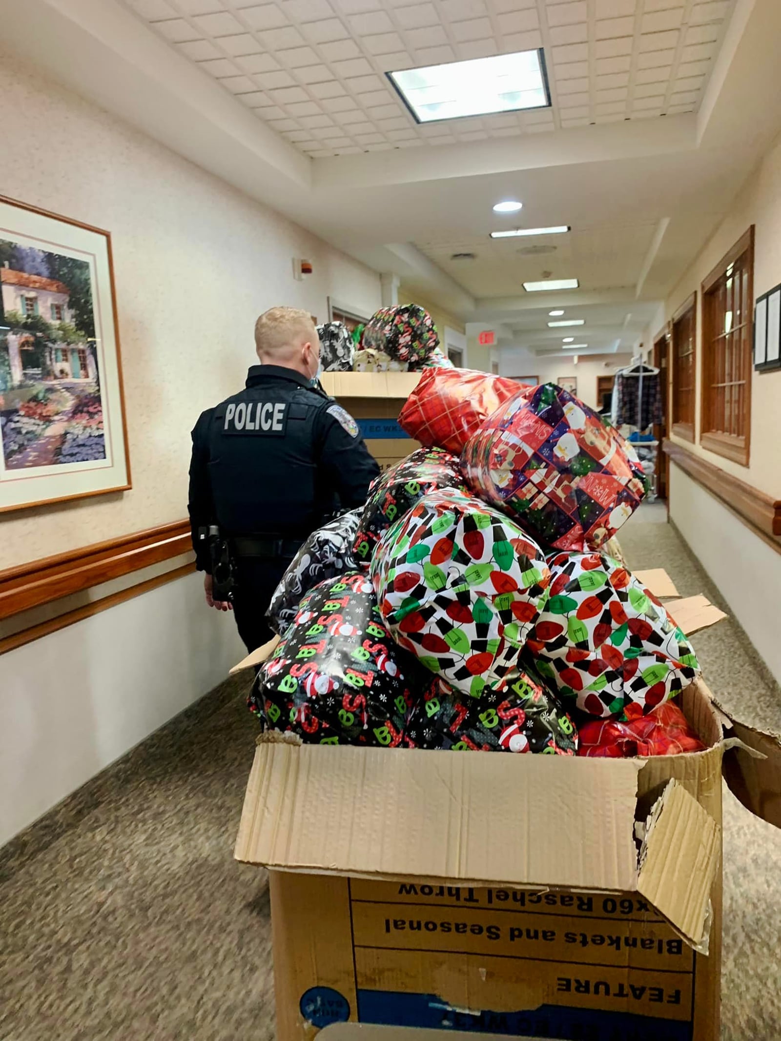 The Fairfield Twp. Police Department purchased gifts for the 64 residents at Birchwood Care Center, a nursing facility in the township. From left are Detective Emma Edens and Detective Nic Spalding bring in gifts that will be given to residents at the nursing home.