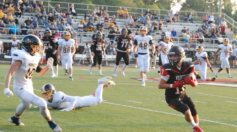 Franklin’s Champ Howard (17) makes a catch and turns upfield against Monroe’s Collin Deaton (10) during a Sept. 14 game at Atrium Stadium in Franklin. The host Wildcats won 24-3. CONTRIBUTED PHOTO BY OLIVER SANDERS