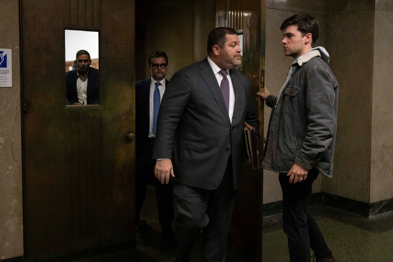 Wayne Gosnell, center, attorney for John Woeltz, cryptocurrency investor charged for kidnapping and false imprisonment, exits a courtroom, Wednesday, May 28, 2025, in New York. (AP Photo/Yuki Iwamura)