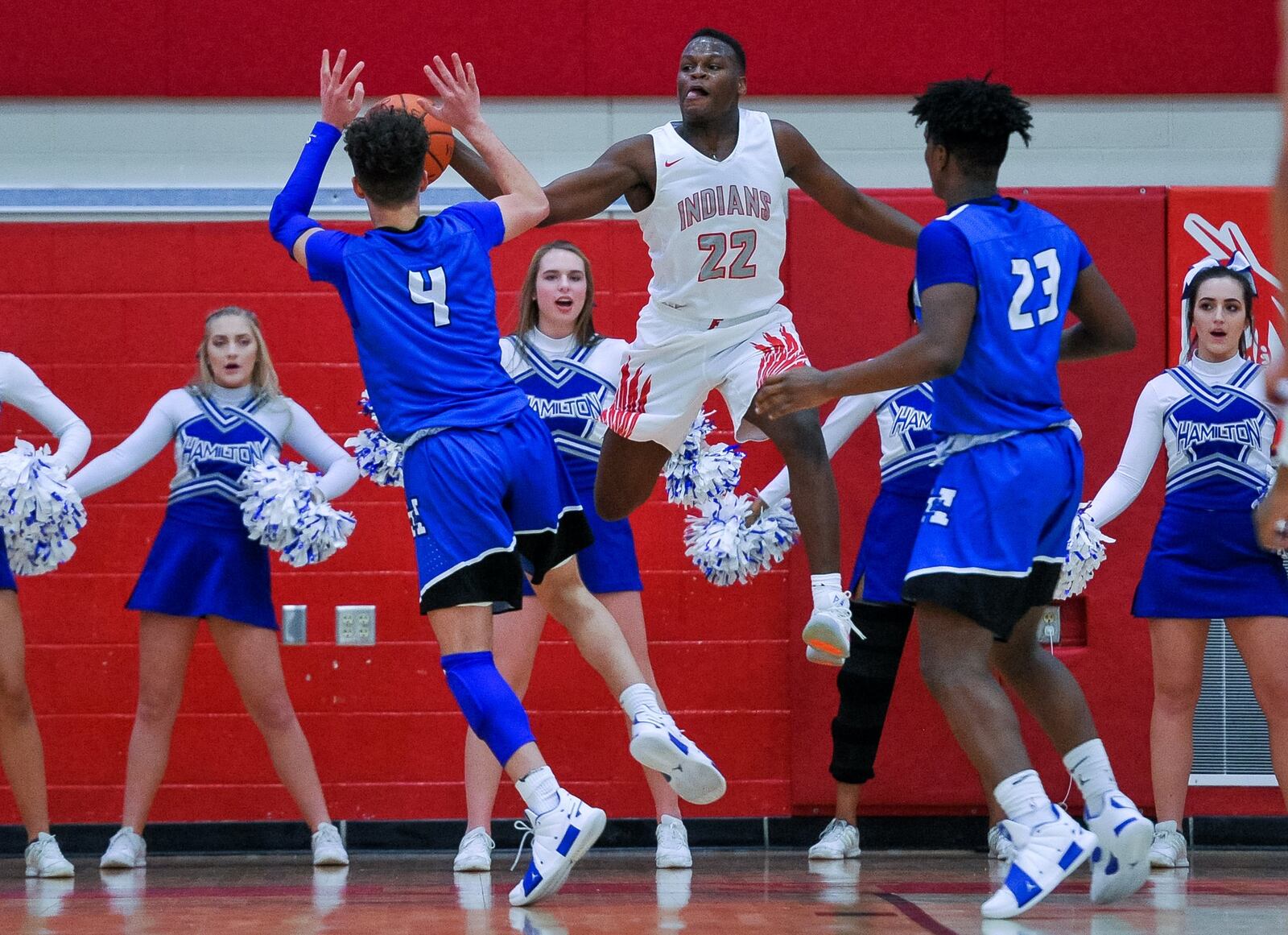 Fairfield’s Courtland Smith (22) jumps to stop the ball from going out of bounds as he is defended by Hamilton’s Jaylen Robinson (4) and Romello Diablo (23) during Friday night’s game at the Fairfield Arena. Hamilton won 57-42. NICK GRAHAM/STAFF