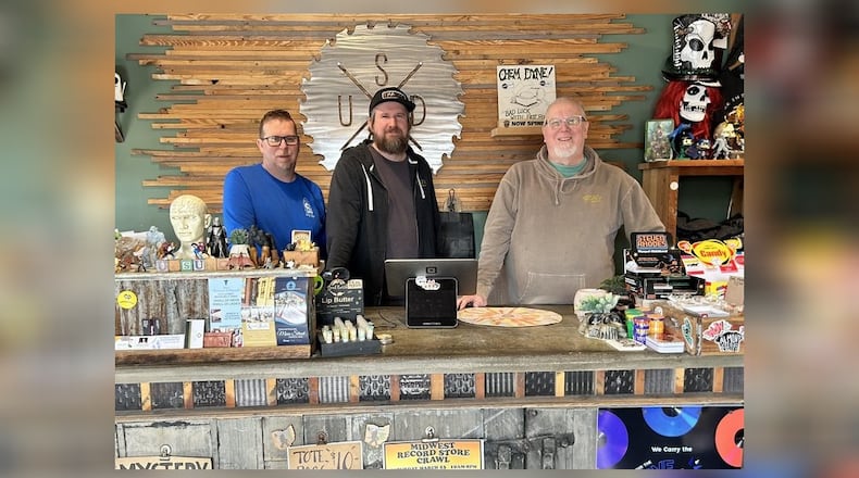 Located on Hamilton’s Main Street, Unsung Salvage offers everything from custom repurposed furniture and art to screen-printed T-shirts, and even vintage records. Pictured, from left, are Jason Carder, Justin Carder, and Dondi Carder. CONTRIBUTED