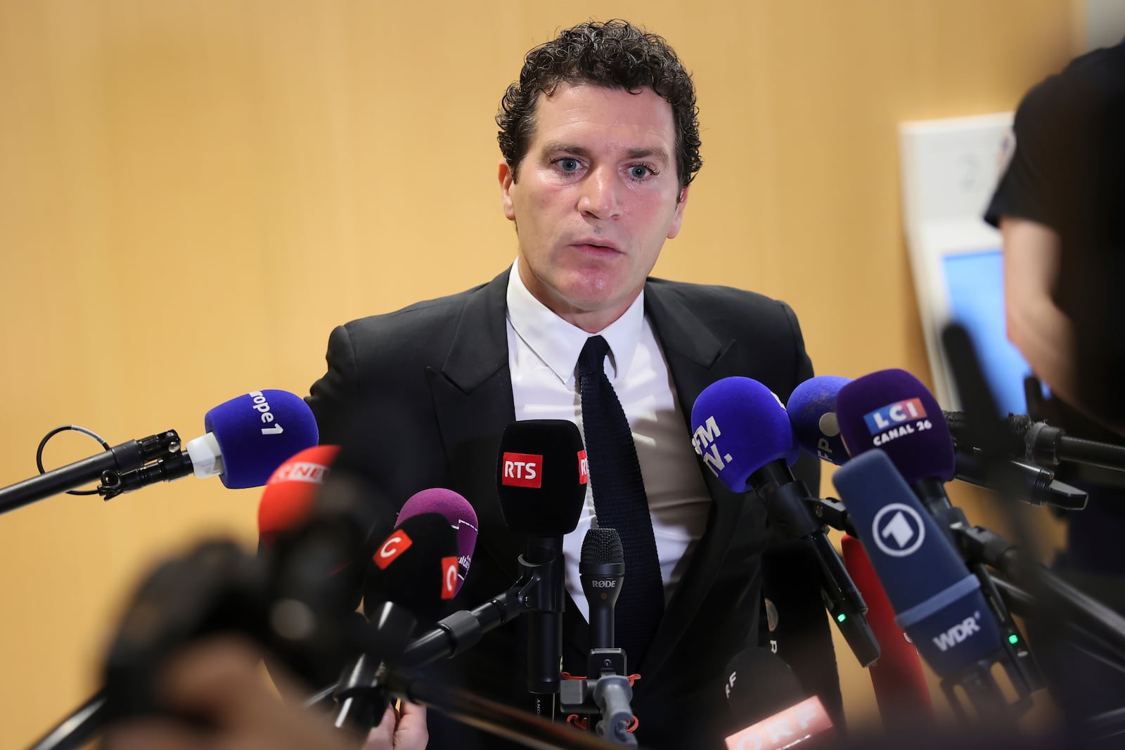 French actor Gerard Depardieu's lawyer Jeremie Assous speaks with the media after a verdict was delivered on accusations that the actor sexually assaulted two women who were working on a film with him in 2021, in Paris, Tuesday, May 13, 2025. (AP Photo/Thomas Padilla)