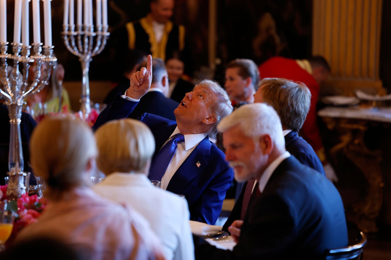 President Donald Trump, center, speaks with Netherland's King Willem Alexander during a dinner at the Paleis Huis ten Bosch ahead of the NATO summit in The Hague, Netherlands, Tuesday, June 24, 2025. (Remko de Waal, Pool Photo via AP)