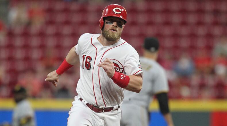 The Reds’ Tucker Barnhart rounds third base and scores in the first inning against the Pirates on Tuesday, May 22, 2018, at Great American Ball Park in Cincinnati. David Jablonski/Staff