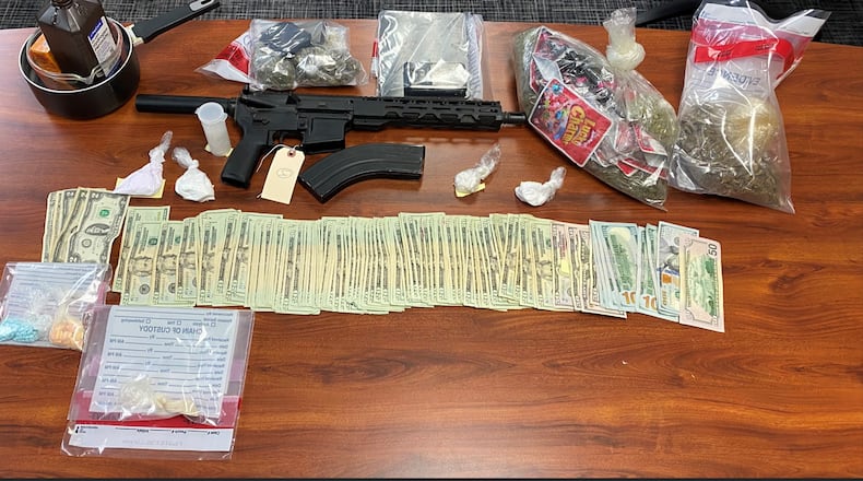 Craig Douglas, a 33-year-old Fairfield man, was charged Wednesday morning, Jan. 29, 2025, at his Fairfield apartment on four drug-related felonies, two of which were for trafficking, according to the Butler County Sheriff’s Office. Pictured are the drugs, a pistol and cash confiscated after the arrest. PROVIDED