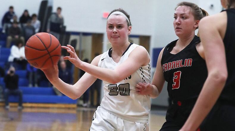 Valley View’s Claire Henson passes the ball off as she runs into pressure from Franklin’s Kaylee Harris during Tuesday night’s Division II regional semifinal at Springfield. Franklin won 47-39 in overtime. BILL LACKEY/STAFF