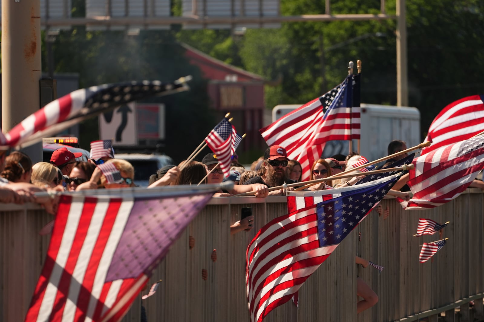A crowd gathers on an overpass over I-90 to honor the firefighters who were killed Sunday, in Coeur d'Alene, Idaho, on Tuesday, July 1, 2025. (AP Photo/Lindsey Wasson)