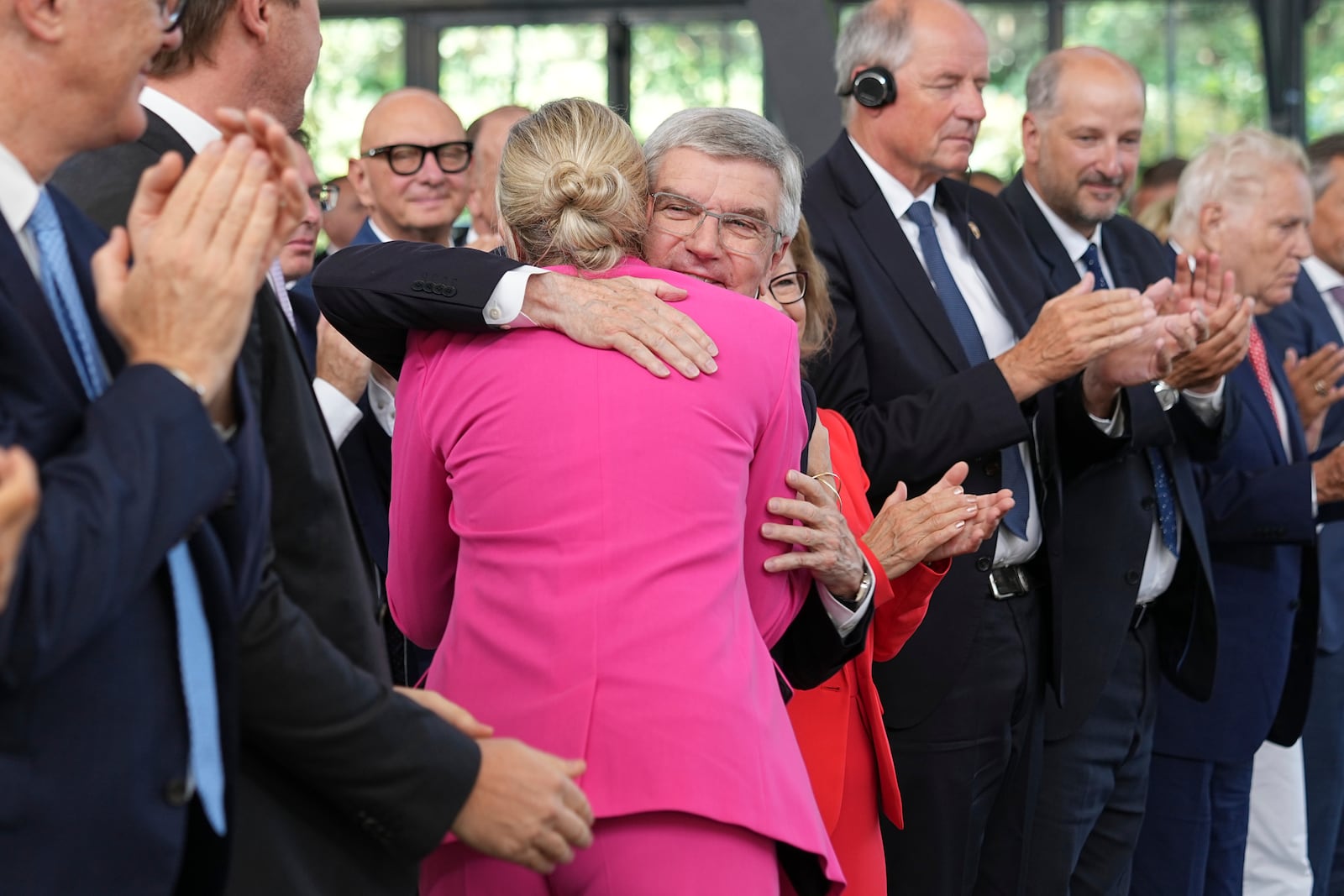 The outgoing IOC President Thomas Bach, right, hugs the new ICO President Kirsty Coventry during the handover ceremony of the IOC Presidency at Olympic House in Lausanne, Switzerland, Monday, June 23, 2025. (AP Photo/Laurent Cipriani)