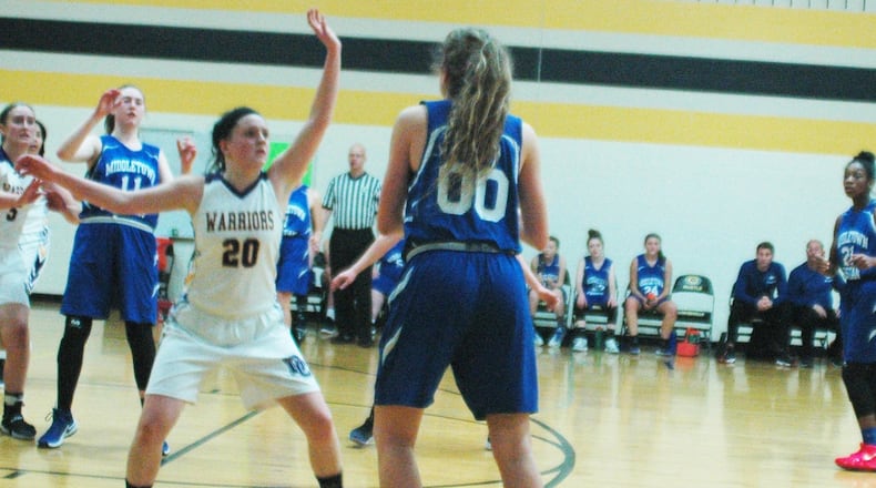 Dayton Christian’s Hannah Kitchens (20) defends Middletown Christian’s Anna Crawford (00) during Thursday night’s game at Watts Middle School in Centerville. Dayton Christian won 48-35. RICK CASSANO/STAFF