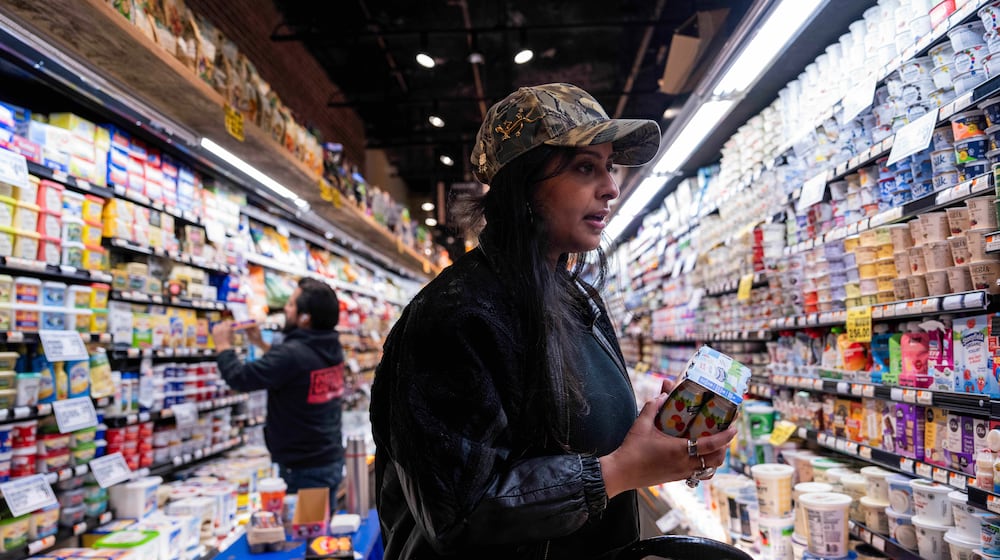 Kashish Ali shops for groceries before filling a One Love Community Fridge, Nov. 15, 2025, in Brooklyn, New York. (AP Photo/Adam Gray)
