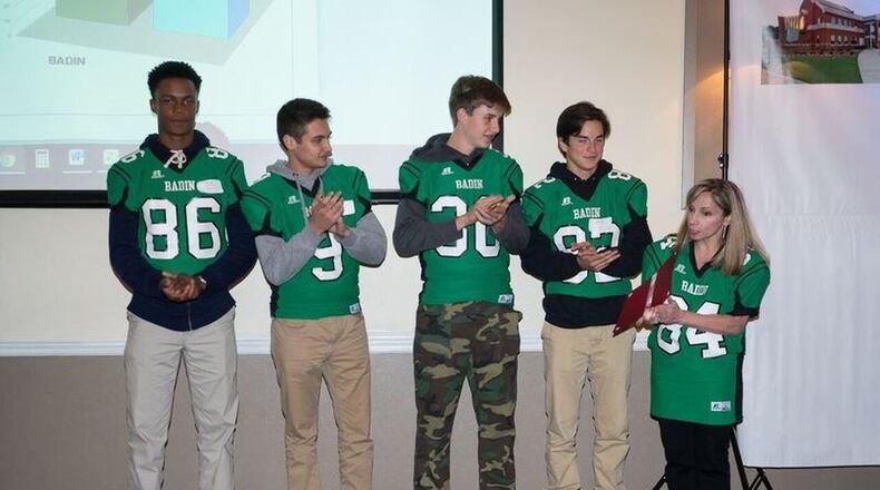 Sarah Daniels (right) director of the Badin High School’s Art Studio, as well as an art teacher and adviser at the school, presents an award from Fairfield Community Foundation to students Jack Chew, Warren Clarke, John Marot and Dominic Scalf at the foundation’s annual meeting in October. CONTRIBUTED