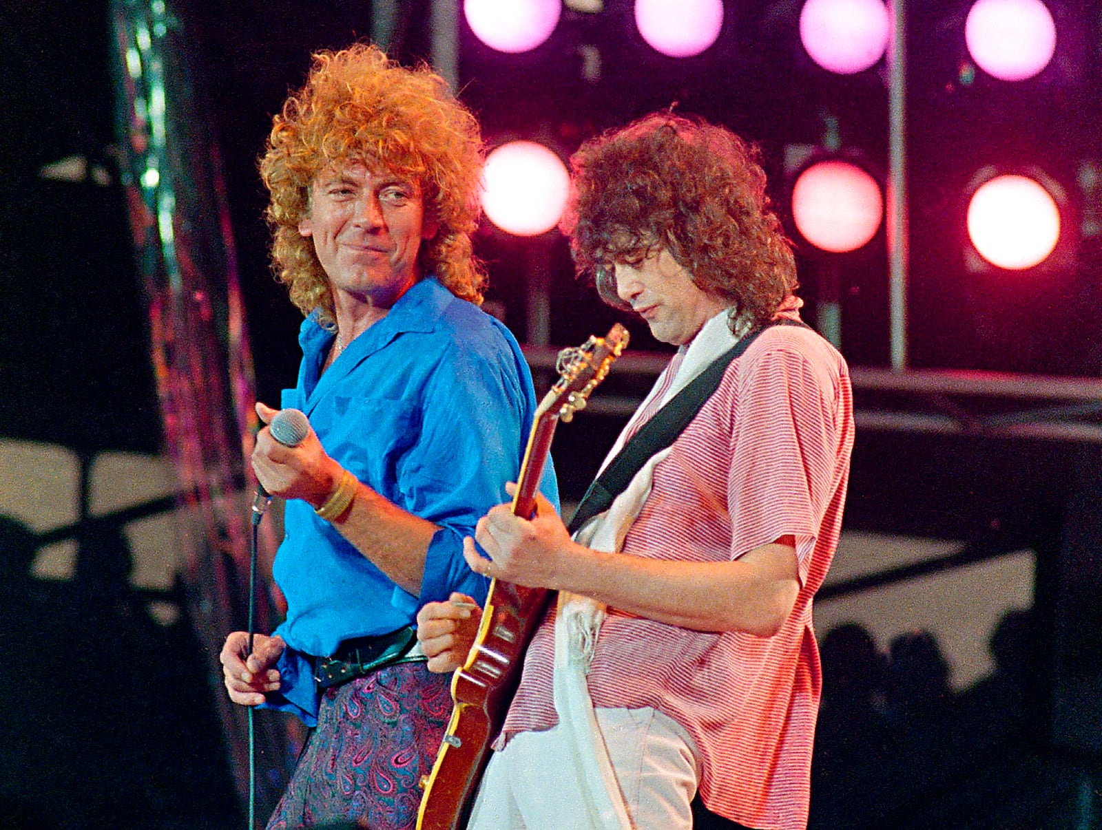 FILE - Led Zeppelin bandmates, singer Robert Plant, left, and guitarist Jimmy Page, perform for the Live Aid famine relief concert at JFK Stadium in Philadelphia on July 13, 1985. (AP Photo/Amy Sancetta, File)
