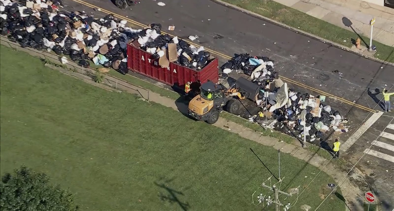 Trash is cleaned up at a drop-off site in Philadelphia as thousands of city workers remained on strike Tuesday, July 8, 2025. (WPVI-TV via AP)