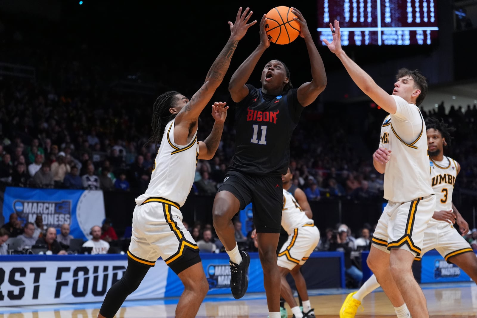 Howard guard Ose Okojie (11), center, shoots during the second half in a First Four college basketball game in the NCAA Tournament against UMBC, Tuesday, March 17, 2026, in Dayton, Ohio. (AP Photo/Kareem Elgazzar)