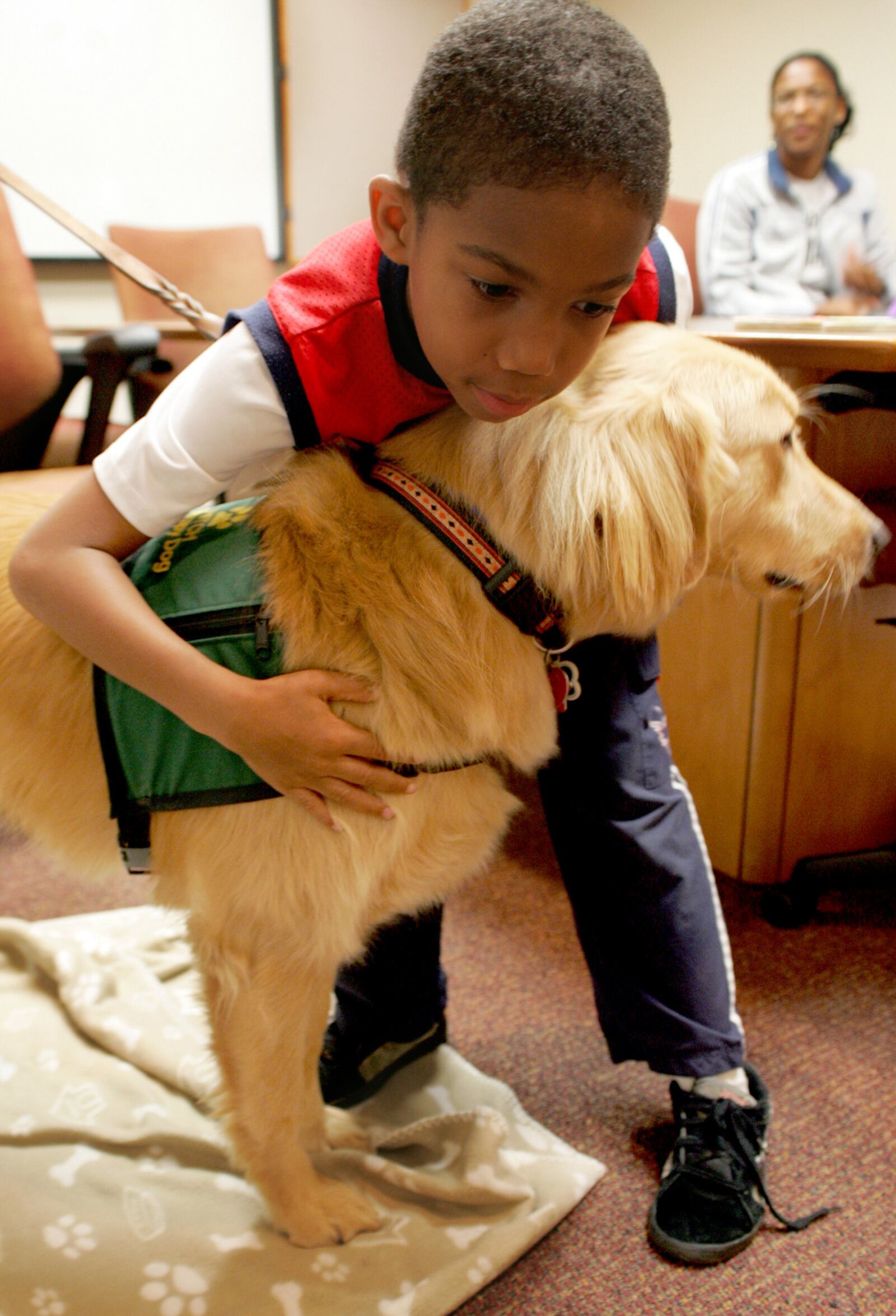 Warren Bess, 8, of Colerain Twp., hugs Hitch, the registered therapy dog of Rebecca Townsend, after reading to him at the Fairfield Lane Library Thursday, September 10, 2009. CONTRIBUTED BY E.L. HUBBARD