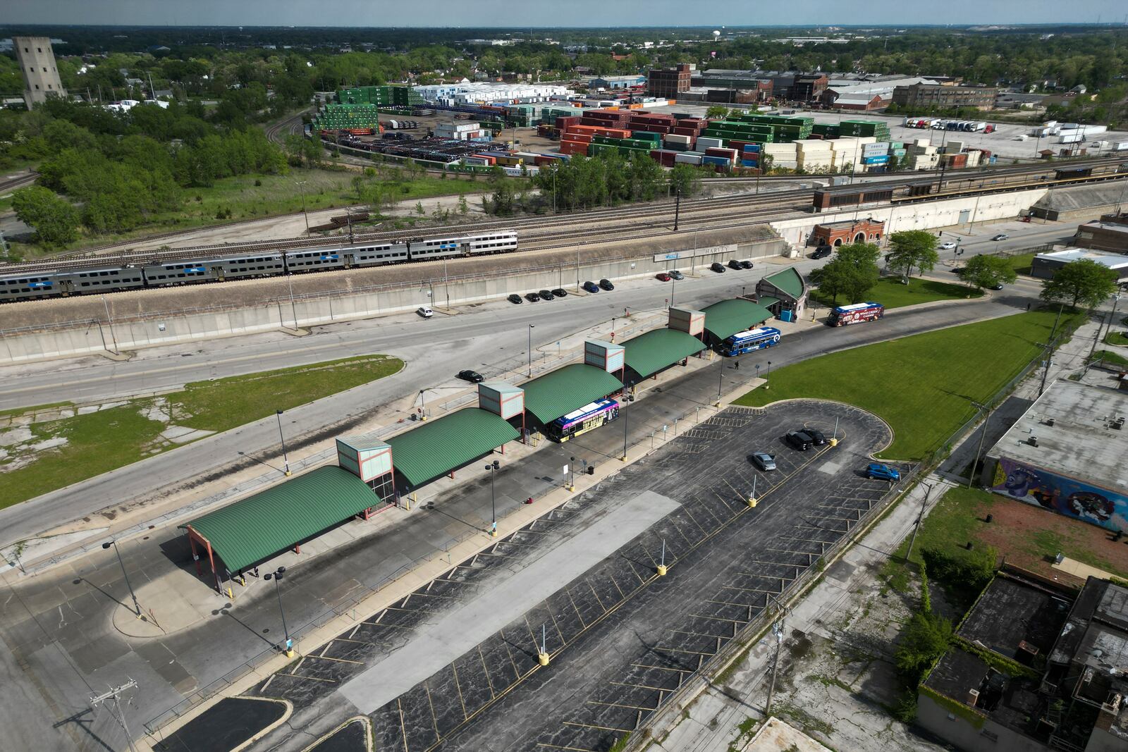 A Metra train, top, is seen in the tracks across from the Pace Harvey Transportation Center, Thursday, May 29, 2025, in Harvey, Ill. (AP Photo/Erin Hooley)