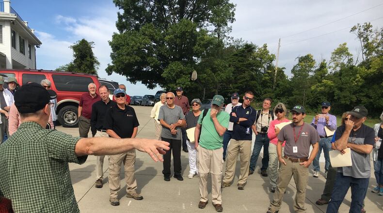 Top state archaeologists and historians were among those who gathered in late August to visit the 2,000-year-old Hopewell earthworks in Ross Township known as the Fortified Hill works. Before walking about half a mile to the site, they heard a description of the property, which will be auctioned for an estate settlement Sept. 28. MIKE RUTLEDGE/STAFF