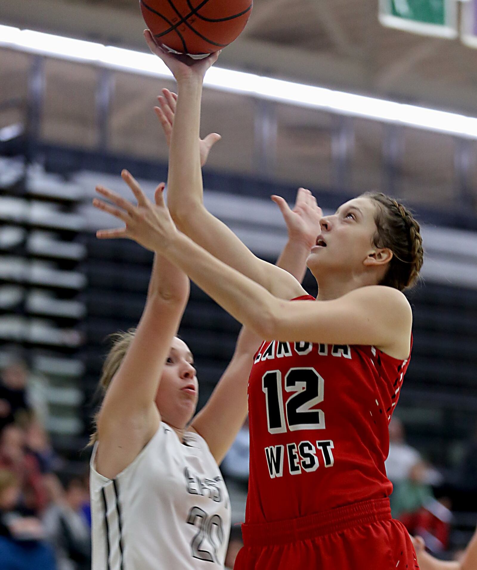 Lakota West forward Emma Haynes shoots while being covered by Lakota East guard Grace Silverberg during their game in Liberty Township on Wednesday night. CONTRIBUTED PHOTO BY E.L. HUBBARD