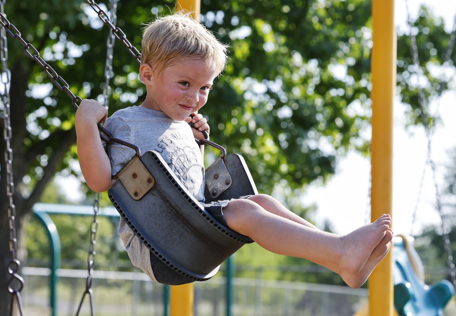 Drew Puckett, 3, plays at a park Thursday, Aug. 26, 2021 in Hanover Township. Puckett was treated by Shriner's Children's Ohio for severe burns to his feet last year after he walked through hot coals that remained after a campfire. NICK GRAHAM / STAFF