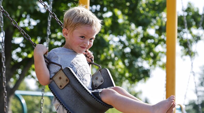 Drew Puckett, 3, plays at a park Thursday, Aug. 26, 2021 in Hanover Township. Puckett was treated by Shriner's Children's Ohio for severe burns to his feet last year after he walked through hot coals that remained after a campfire. NICK GRAHAM / STAFF