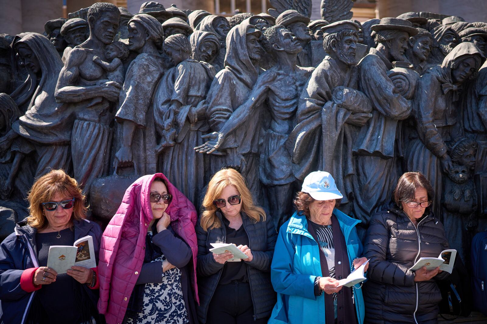 Faithful listen to mass during the funeral of Pope Francis in St. Peter's Square at the Vatican, Saturday, April 26, 2025. (AP Photo/Emilio Morenatti)