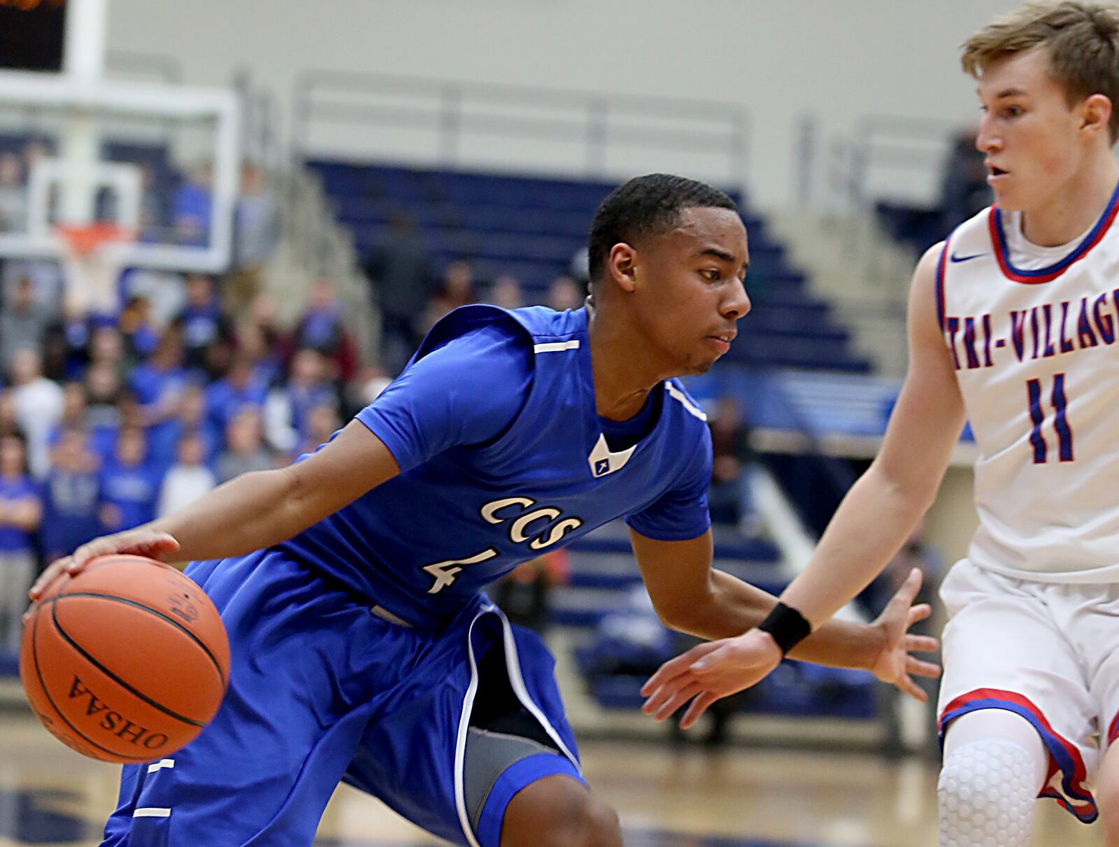 Cincinnati Christian’s Dylan Woods drives on New Madison Tri-Village’s Gavin Richards during Tuesday night’s Division IV regional semifinal at Fairmont’s Trent Arena. CONTRIBUTED PHOTO BY E.L. HUBBARD