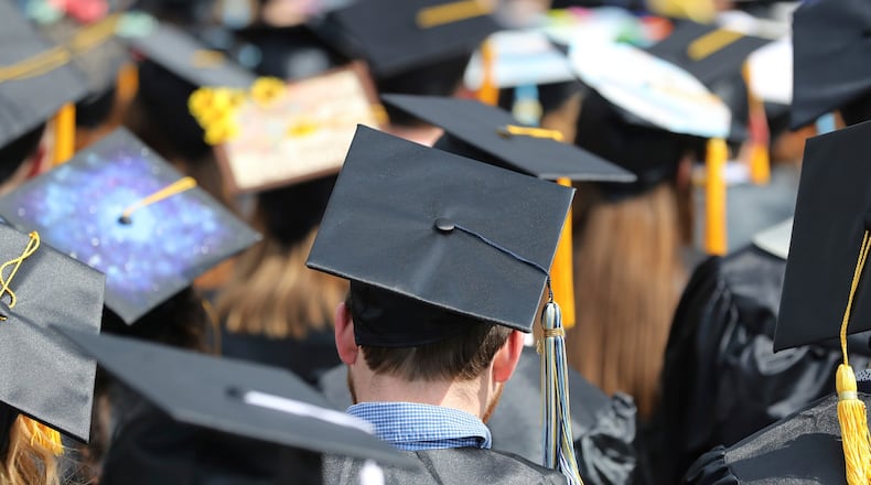 FILE - In this May 5, 2018, file photo, graduates at the University of Toledo commencement ceremony in Toledo, Ohio. (AP Photo/Carlos Osorio, File)
