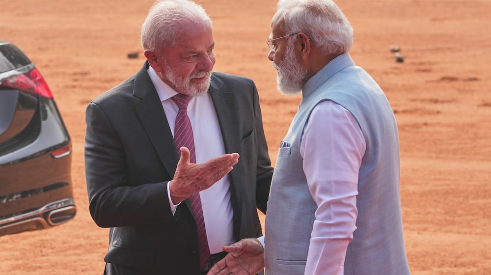 Brazilian President Luiz Inacio Lula da Silva, left, talks with Indian Prime Minister Narendra Modi upon his arrival at the Presidential Palace for his ceremonial reception in New Delhi, India, Saturday, Feb. 21, 2026. (AP Photo/Manish Swarup)